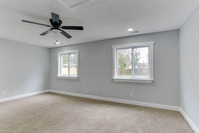 empty room with carpet, recessed lighting, visible vents, a ceiling fan, and baseboards