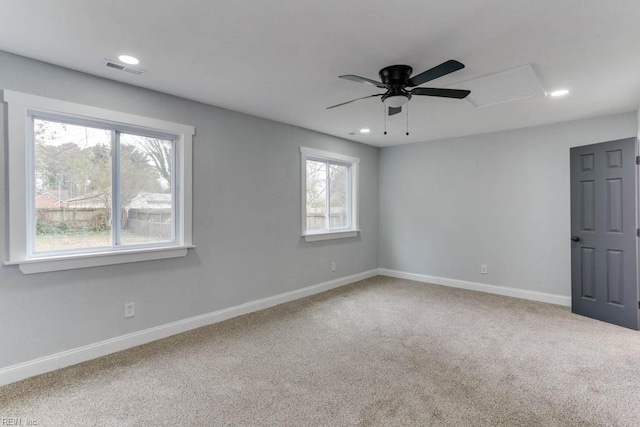 unfurnished room with recessed lighting, carpet flooring, a ceiling fan, visible vents, and baseboards