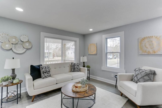 living area featuring recessed lighting, baseboards, and wood finished floors