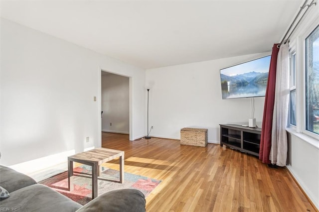 living room with baseboards and light wood-style floors