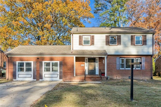 view of front of home featuring a garage, driveway, brick siding, and a front lawn