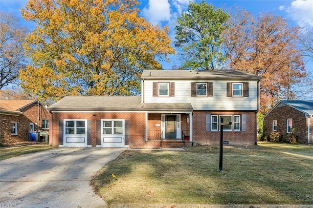 view of front of house featuring a garage, a front yard, brick siding, and driveway