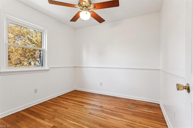 unfurnished room with ceiling fan, baseboards, and wood finished floors