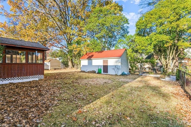 view of yard featuring fence and an outdoor structure