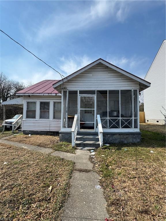 bungalow-style home featuring a sunroom and metal roof