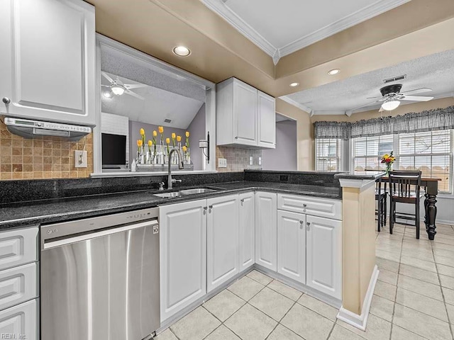 kitchen with light tile patterned floors, dishwasher, a peninsula, crown molding, and a sink