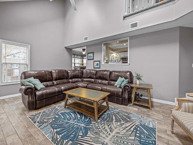 living area featuring a healthy amount of sunlight, visible vents, and wood finished floors