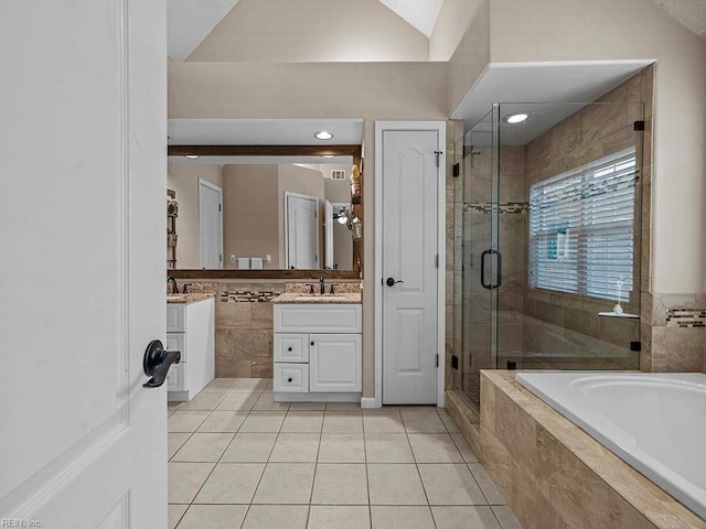 full bathroom featuring a bath, tile patterned flooring, vanity, a shower stall, and tile walls