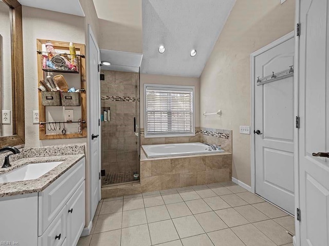 bathroom with a stall shower, lofted ceiling, tile patterned floors, a garden tub, and vanity