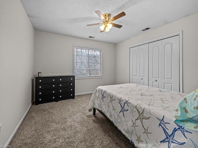 bedroom featuring a closet, carpet flooring, visible vents, and baseboards