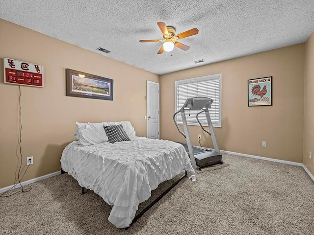 bedroom with carpet, visible vents, a textured ceiling, and baseboards