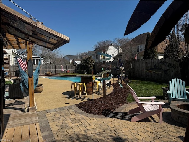 view of patio with a fenced in pool, an outdoor fire pit, and a fenced backyard