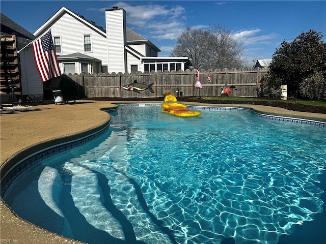 view of swimming pool with fence and a fenced in pool