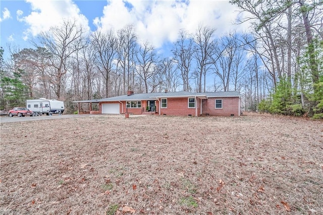 ranch-style home featuring brick siding, crawl space, and an attached garage