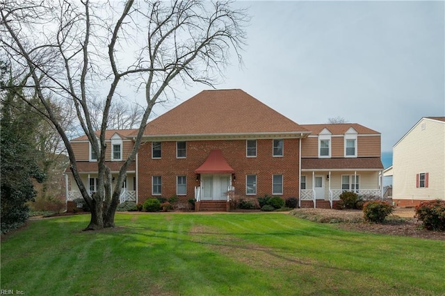 view of front of house with a front yard and brick siding