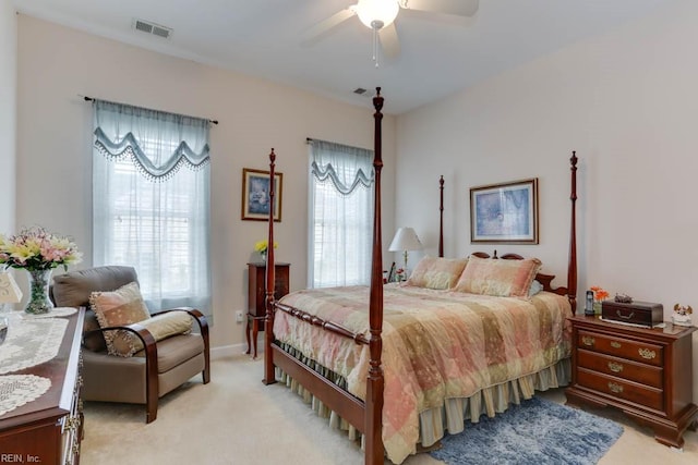 bedroom featuring ceiling fan, visible vents, and light colored carpet