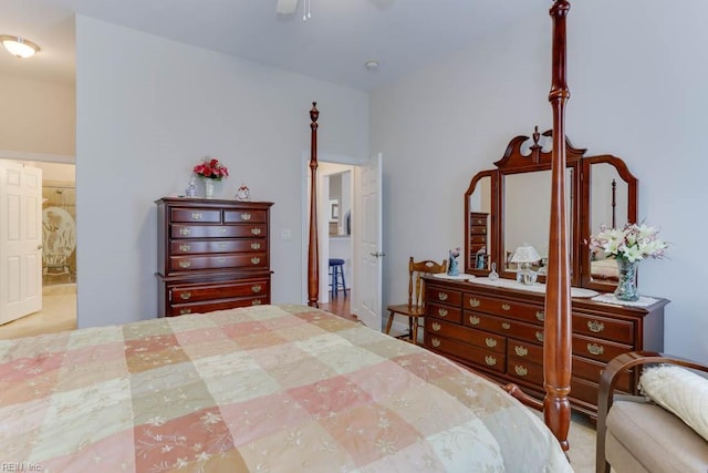 bedroom with ensuite bath and a ceiling fan