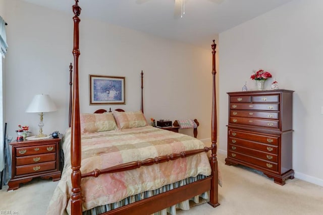 bedroom featuring a ceiling fan, light carpet, and baseboards