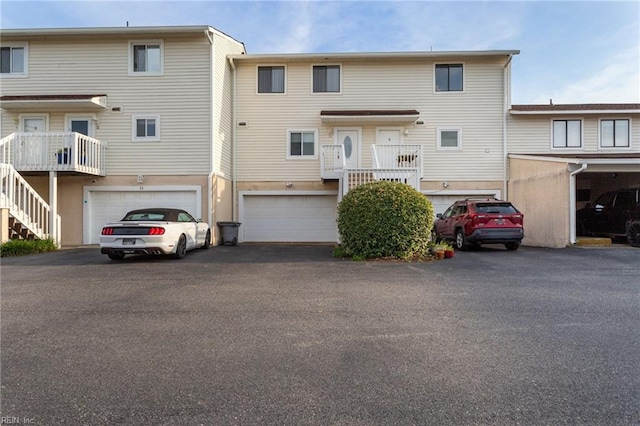 view of front facade featuring a garage, driveway, and stairway