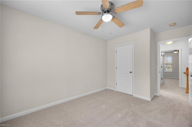 unfurnished bedroom featuring baseboards, ceiling fan, and light colored carpet