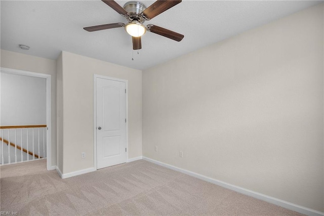 unfurnished bedroom featuring ceiling fan, carpet, and baseboards