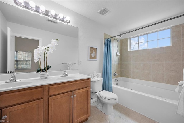 full bath featuring toilet, a sink, and visible vents