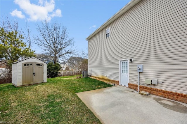 view of yard featuring central AC unit, a patio, an outbuilding, a storage unit, and fence