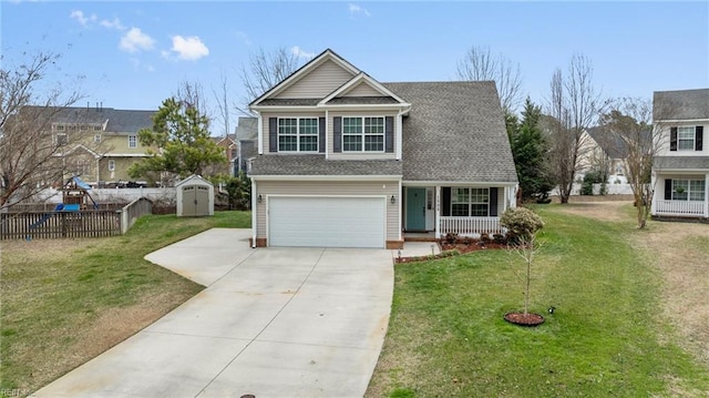 view of front of home with an attached garage, a storage shed, a front yard, fence, and driveway