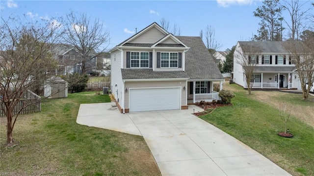 traditional home with central AC unit, concrete driveway, covered porch, fence, and a front yard