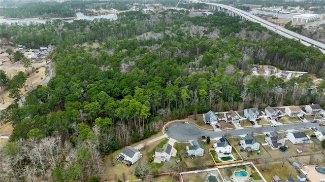 aerial view with a forest view, a water view, and a residential view