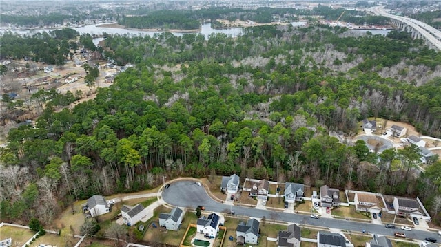 bird's eye view with a forest view, a water view, and a residential view