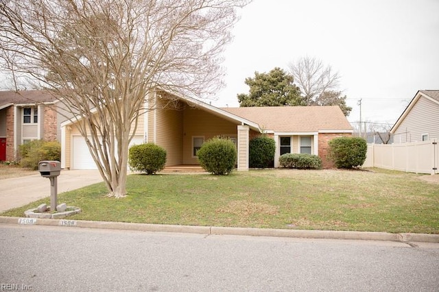 view of front of property featuring a front yard, concrete driveway, fence, and an attached garage