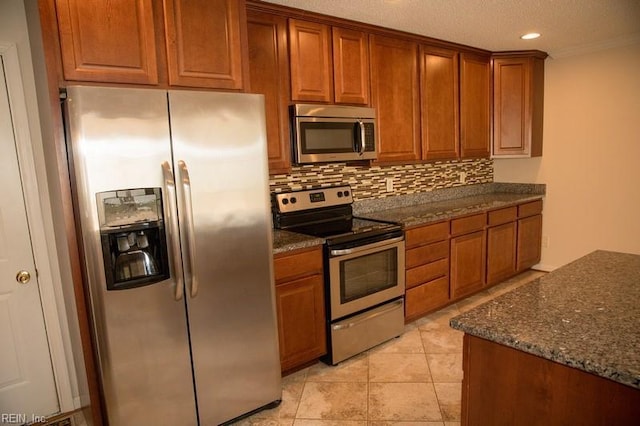 kitchen featuring appliances with stainless steel finishes, brown cabinets, and backsplash