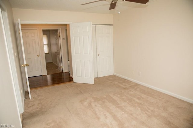 unfurnished bedroom featuring ceiling fan, carpet floors, a closet, and baseboards