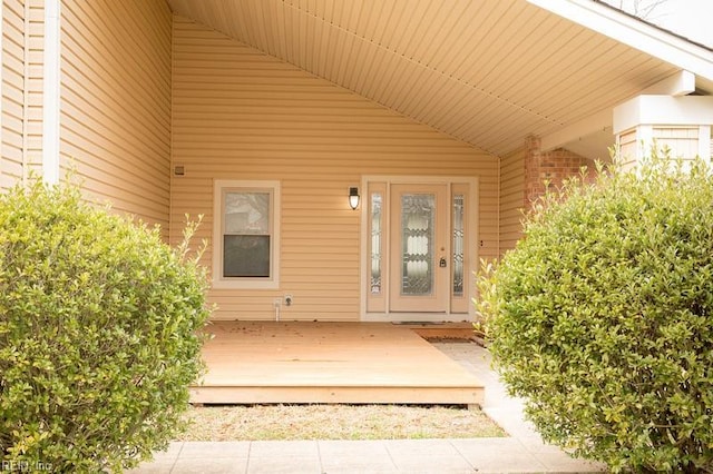 doorway to property featuring brick siding