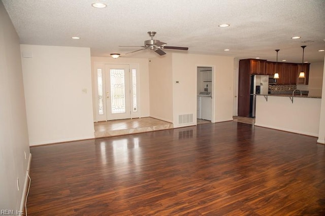 unfurnished living room featuring a textured ceiling, ceiling fan, recessed lighting, wood finished floors, and visible vents