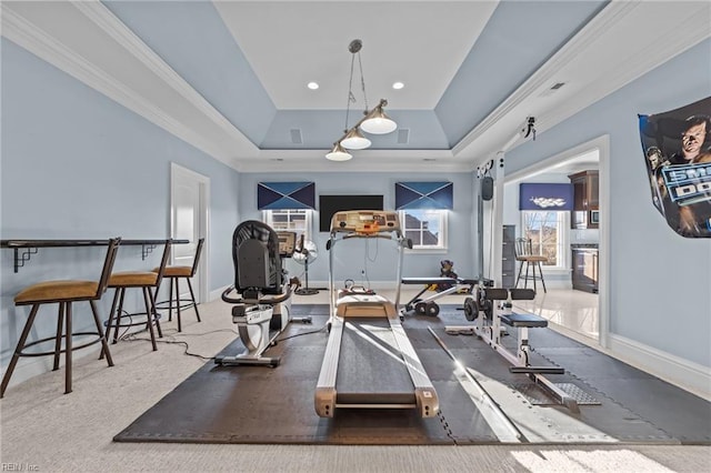 exercise room featuring recessed lighting, visible vents, baseboards, a tray ceiling, and crown molding