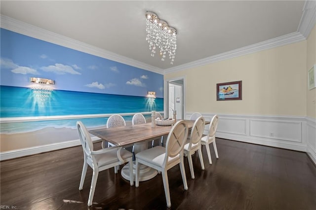 dining space featuring a wainscoted wall, a chandelier, dark wood finished floors, and crown molding