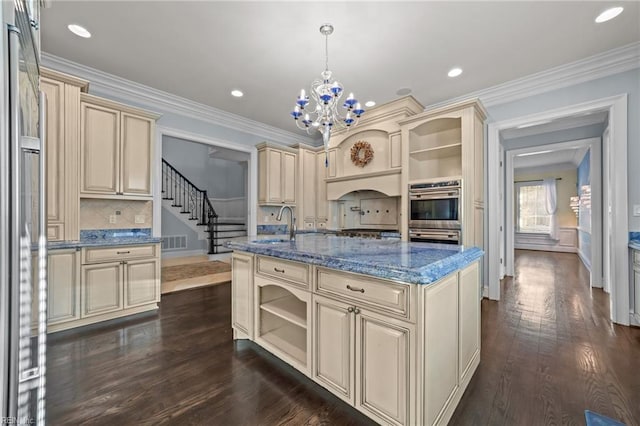 kitchen featuring visible vents, dark wood-style floors, appliances with stainless steel finishes, cream cabinetry, and open shelves