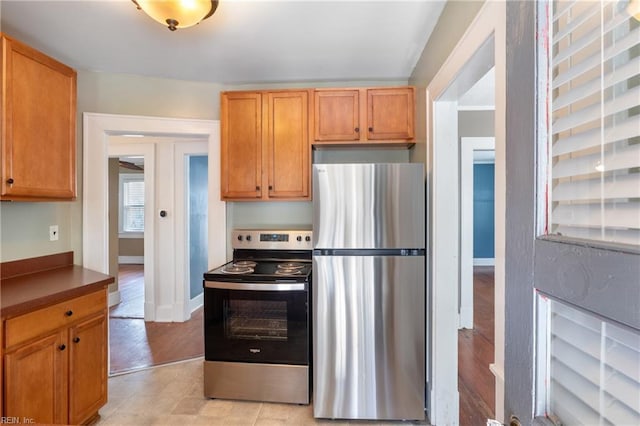 kitchen featuring stainless steel appliances and baseboards