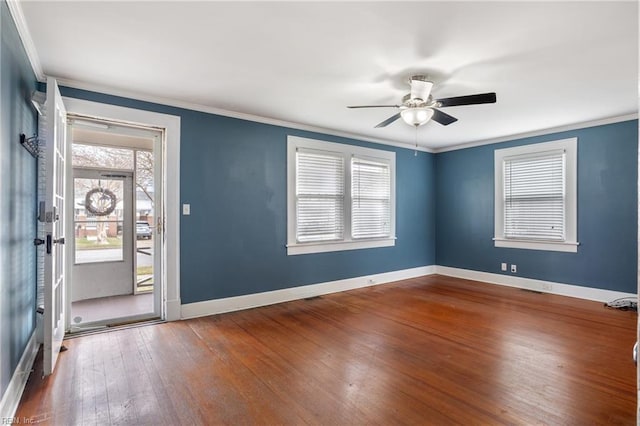 entryway featuring hardwood / wood-style flooring, baseboards, and ornamental molding