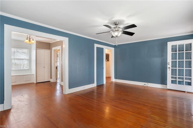 empty room featuring crown molding and wood finished floors