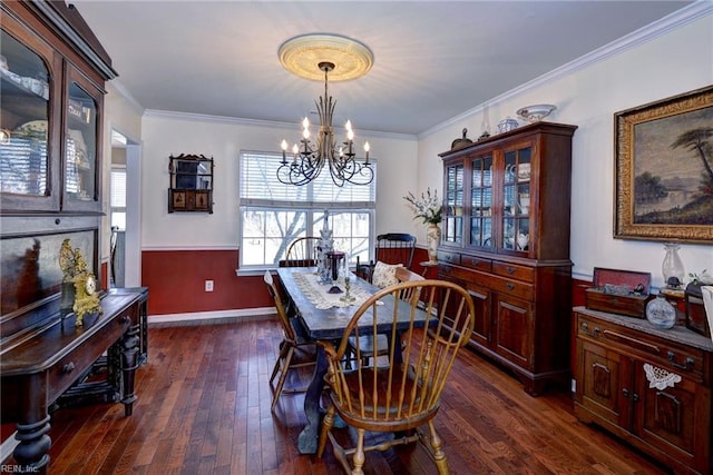 dining space featuring crown molding, a chandelier, dark wood finished floors, and baseboards