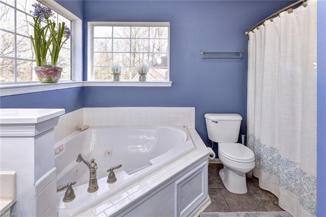 bathroom featuring toilet and a whirlpool tub