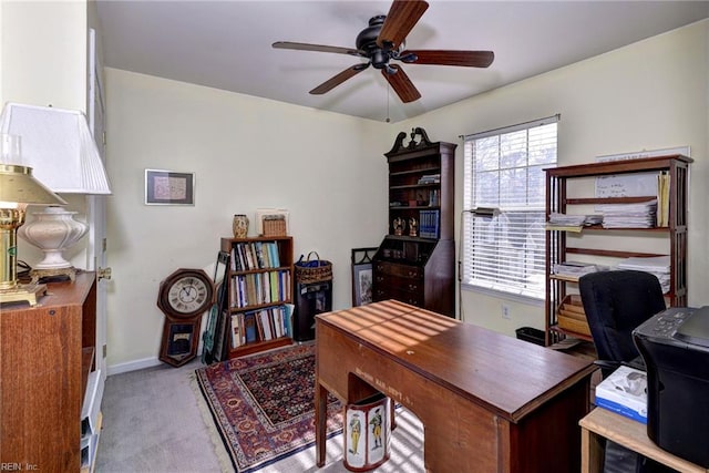 office area with carpet, baseboards, and a ceiling fan