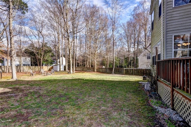 view of yard with a fenced backyard, a shed, and an outdoor structure