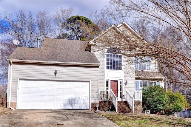 traditional-style house with a garage, driveway, and roof with shingles