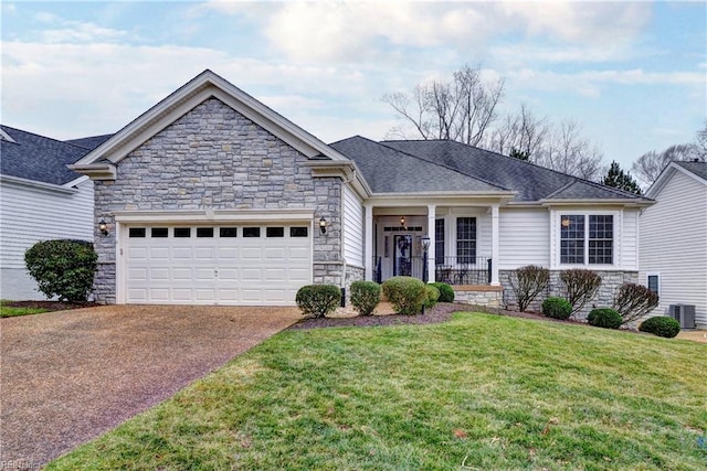 view of front of property with driveway, a garage, stone siding, cooling unit, and a front yard