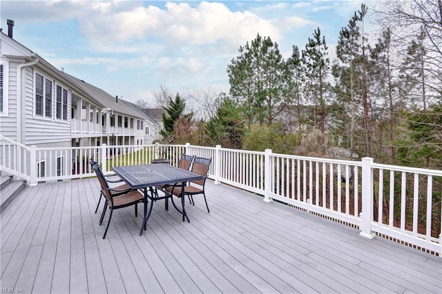 wooden terrace featuring outdoor dining area