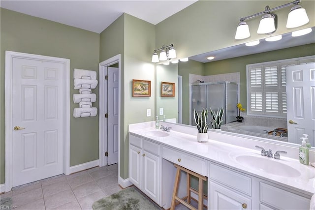 bathroom featuring tile patterned flooring, a sink, a shower stall, and double vanity